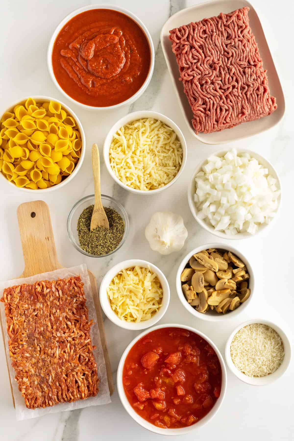 pasta bake ingredients in small white bowls