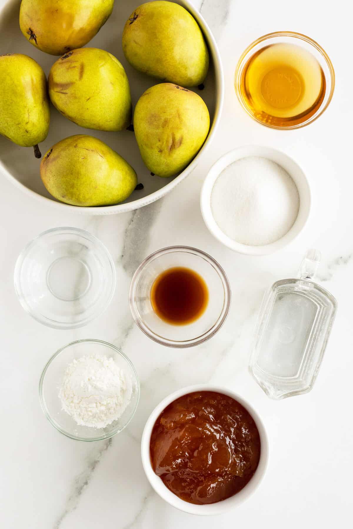 Poached pears ingredients in small white bowls