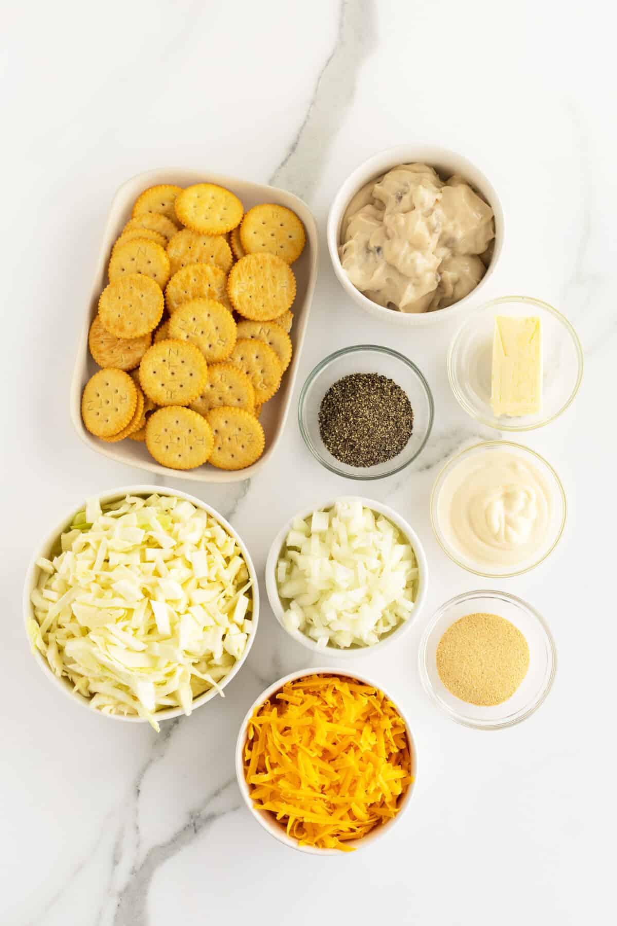 cabbage casserole ingredients in small clear and white bowls