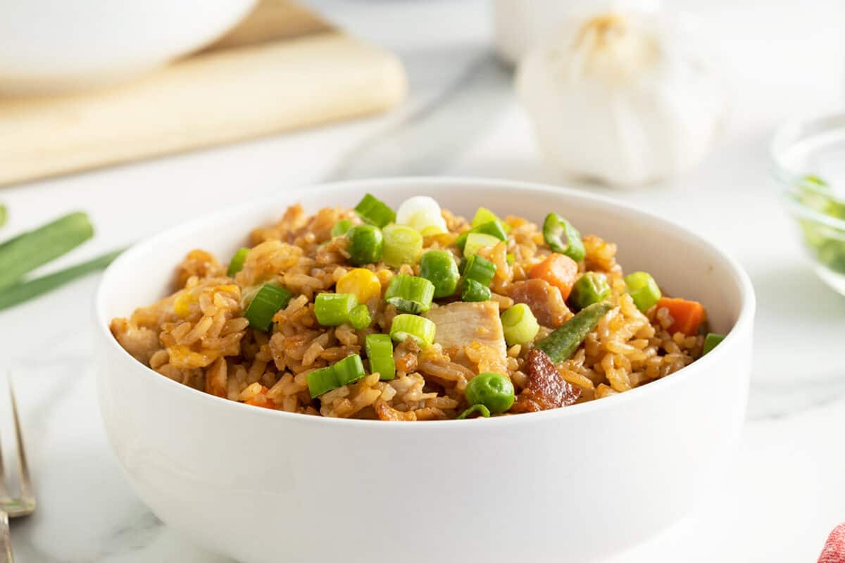 chicken fried rice in a large white bowl 