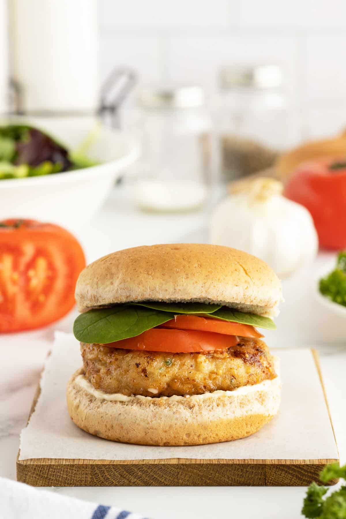 chicken patty in a bun with lettuce and tomato