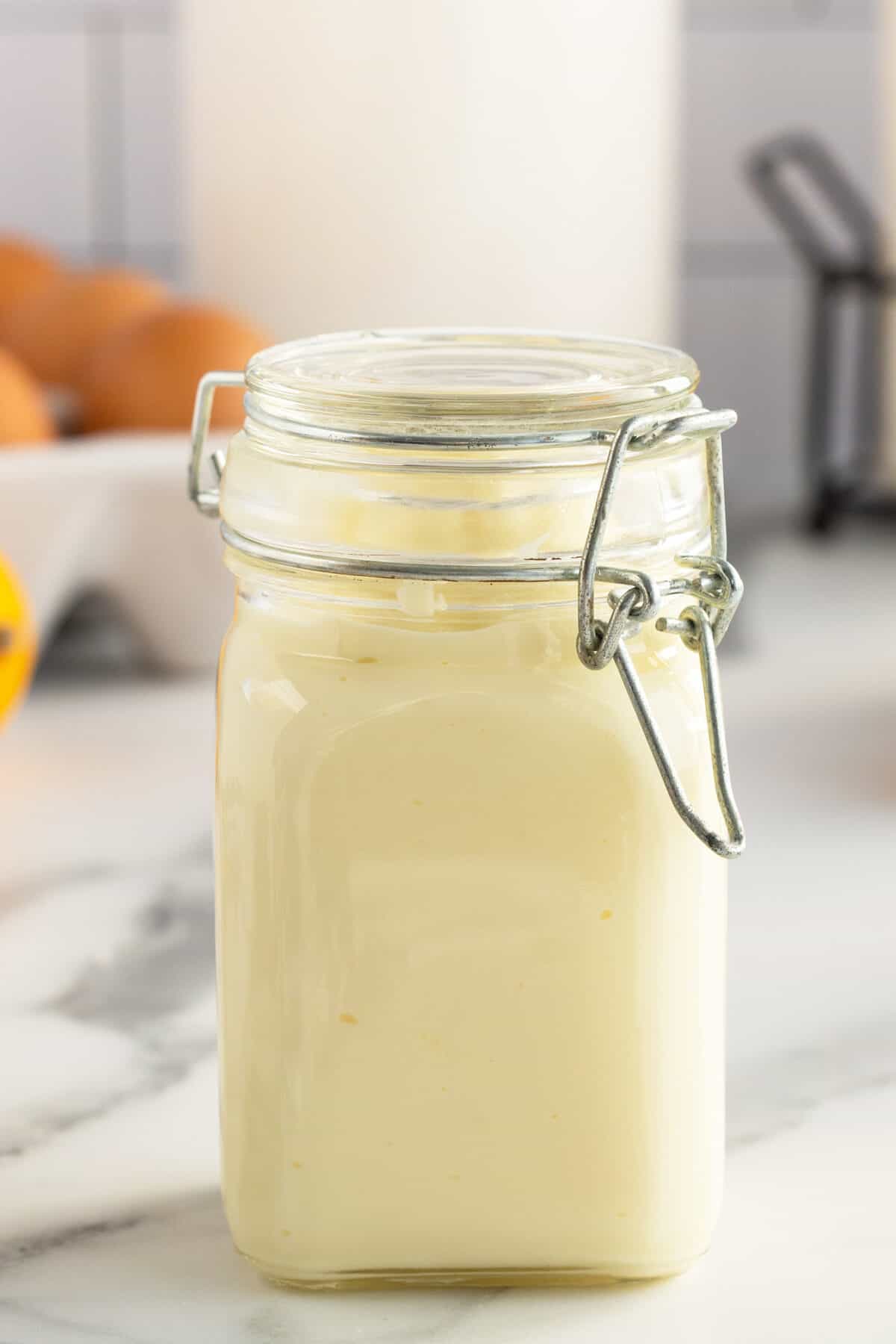 yellow homemade mayonnaise in a mason jar