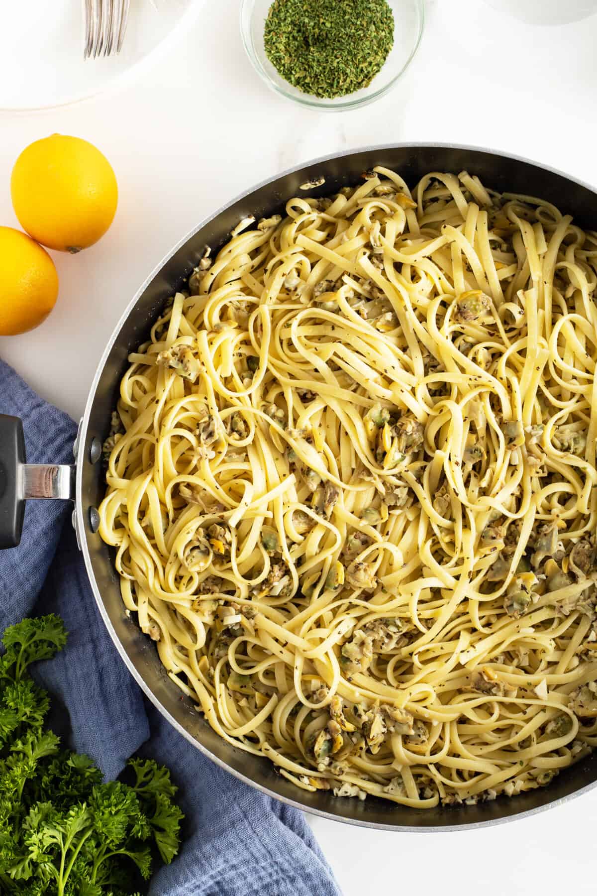 linguini with clam sauce in a pan stirred and ready to serve