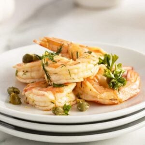 pickled shrimp on a stack of white plates