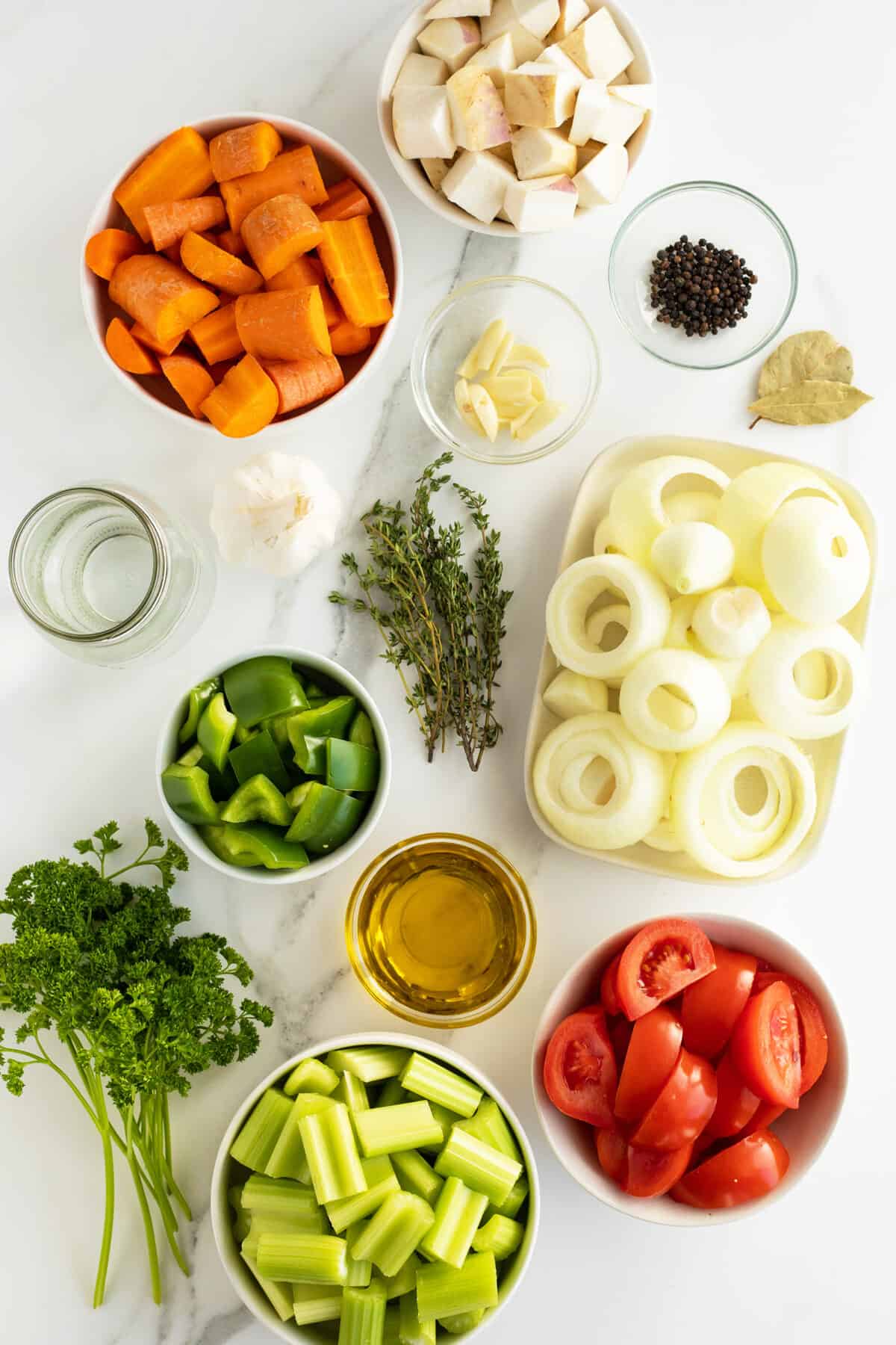 vegetable broth ingredients in medium white  bowls