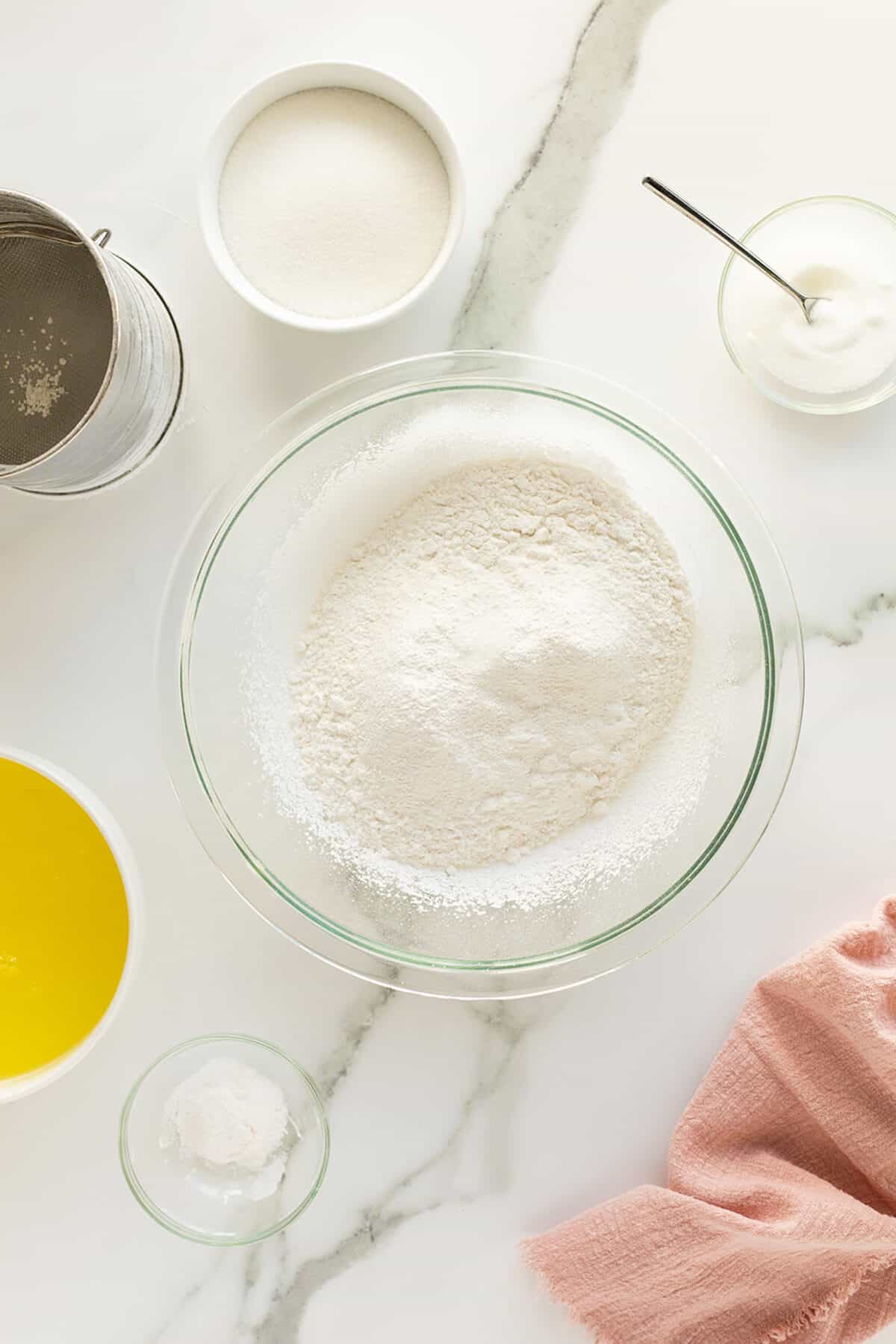 Angel cake dry ingredients in a clear mixing bowl