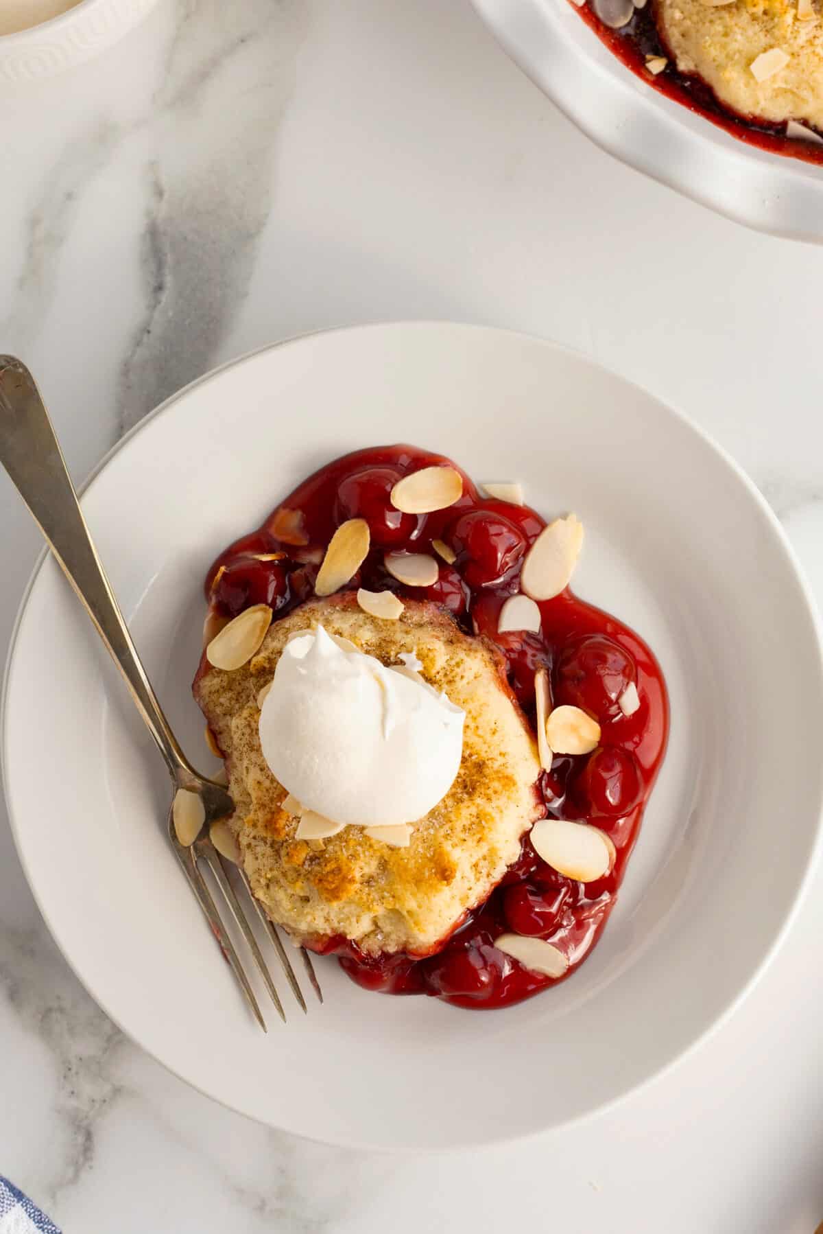 cherry cobbler with a dollop of whipped topping