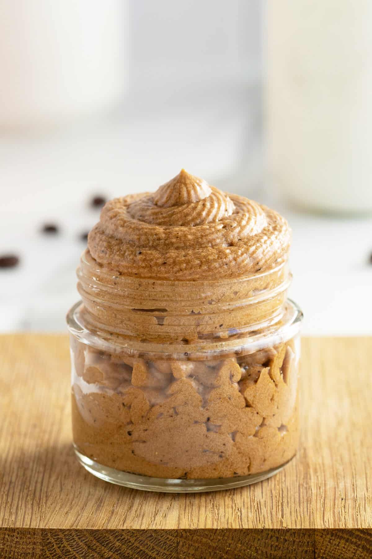 Coffee buttercream icing in a clear jar