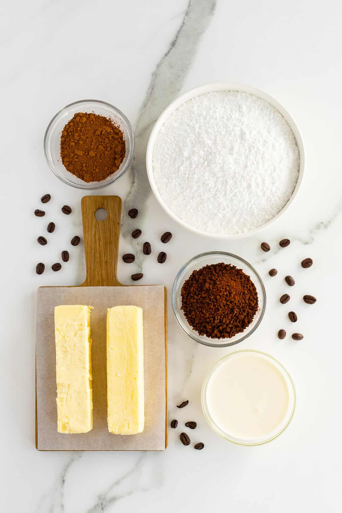 Coffee buttercream icing ingredients in small clear bowls