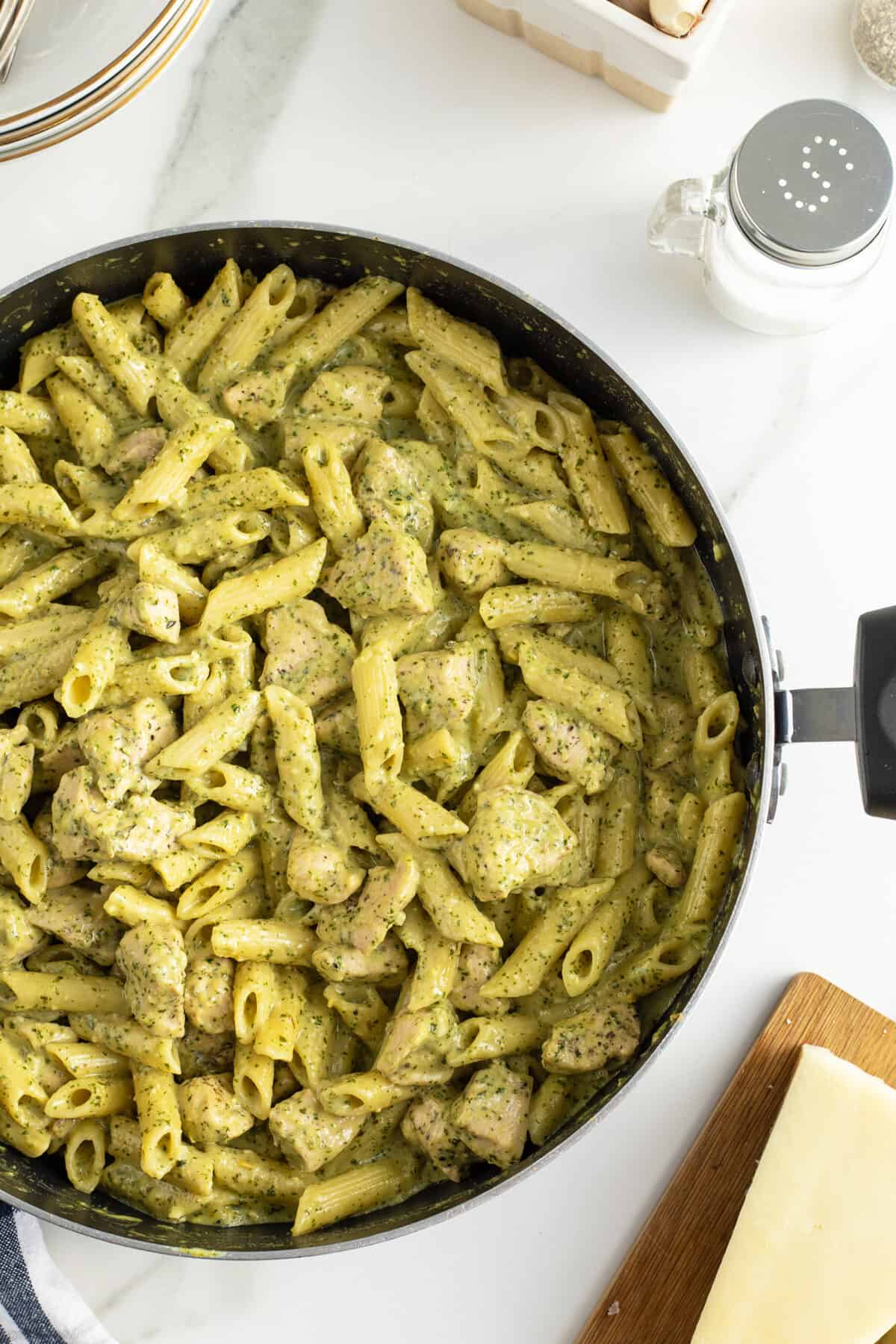 creamy chicken pesto pasta in a large pan