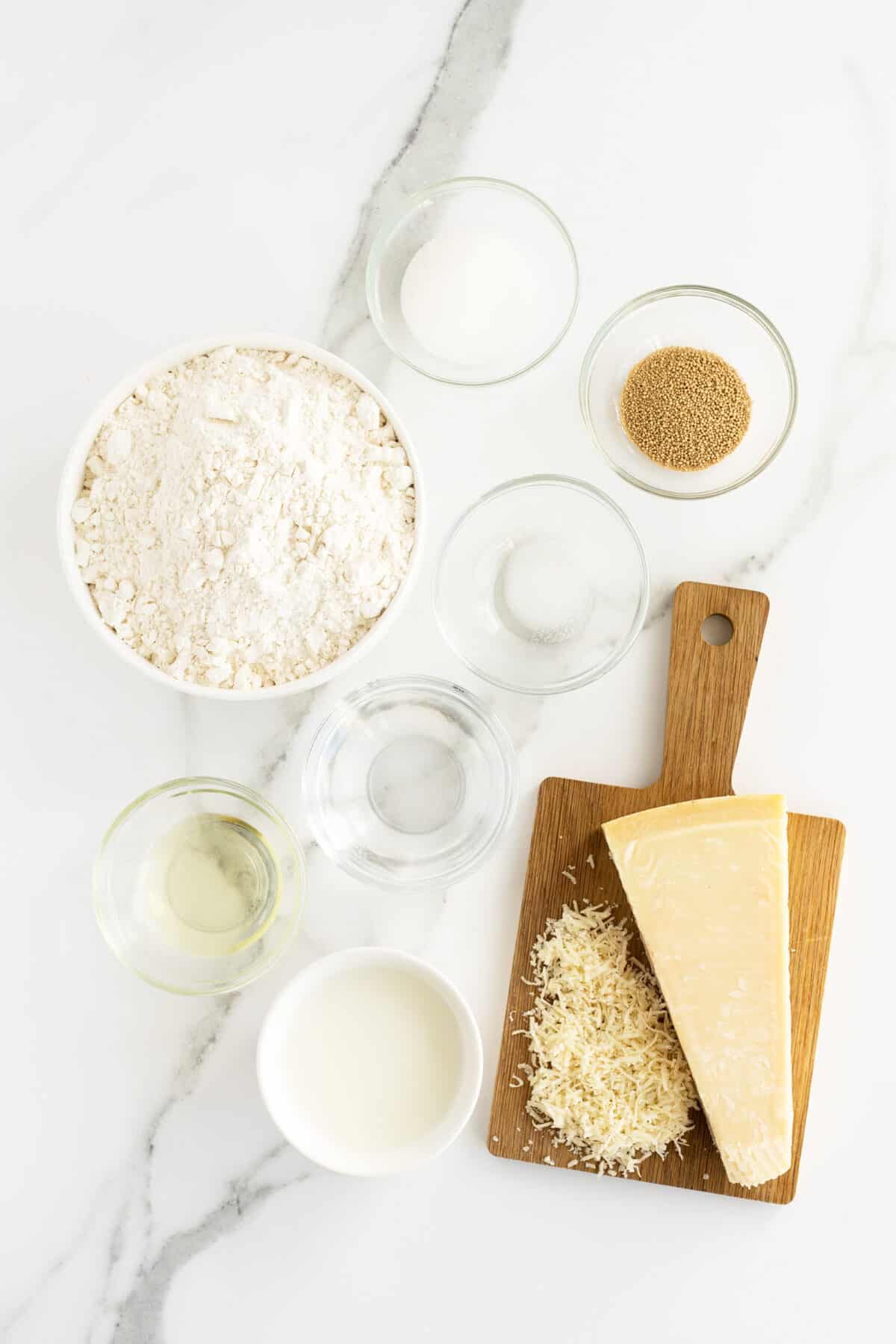 homemade breadsticks ingredients in small clear bowls
