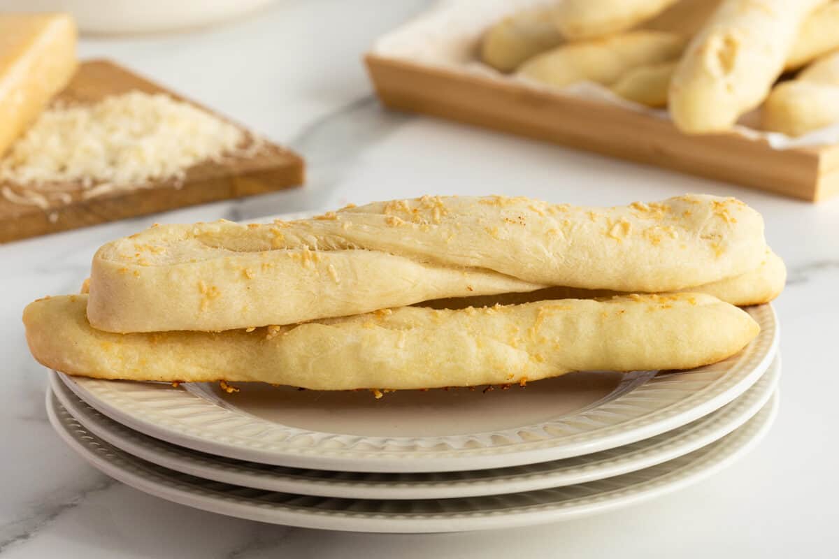 homemade breadsticks on a white plate
