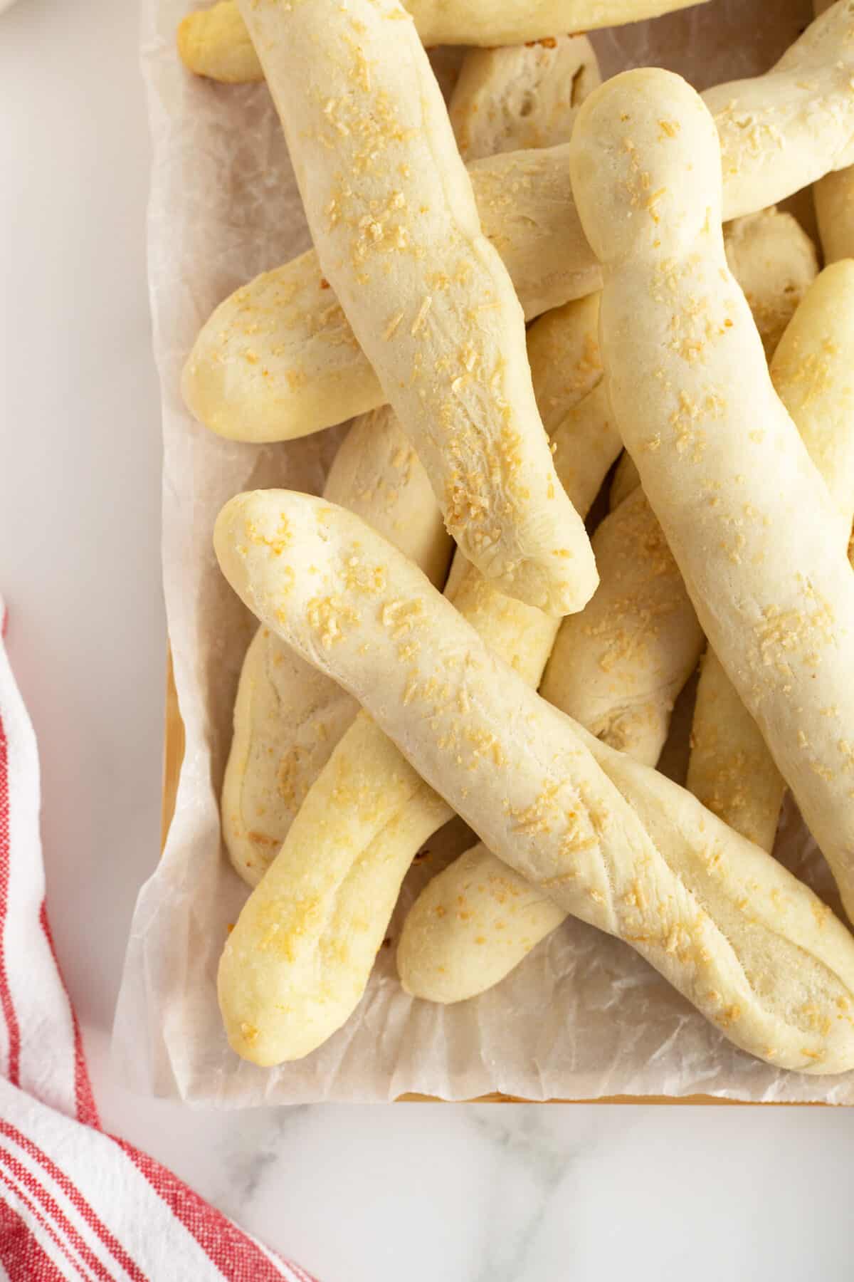 homemade breadsticks overhead view of them on a piece of parchment paper
