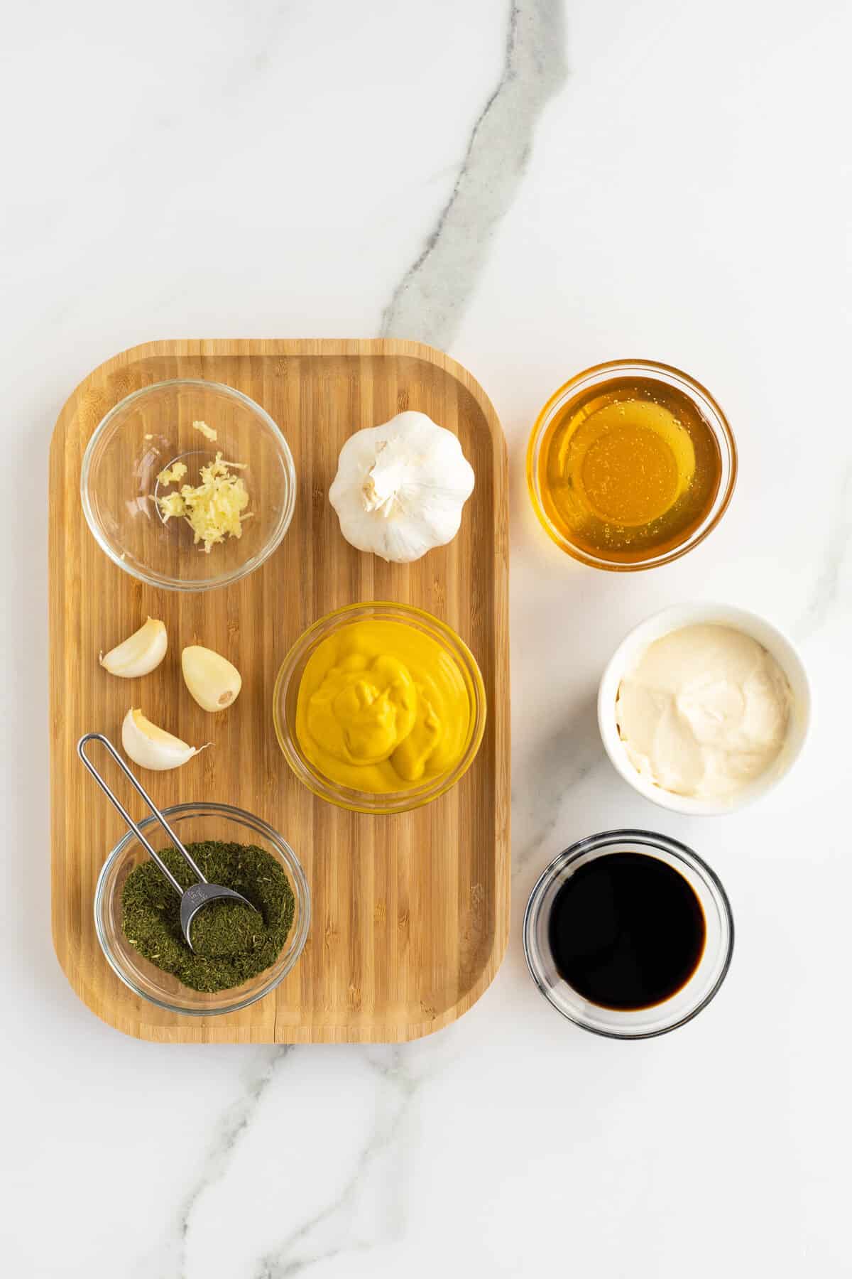 honey mustard dressing ingredients on a wooden cutting board