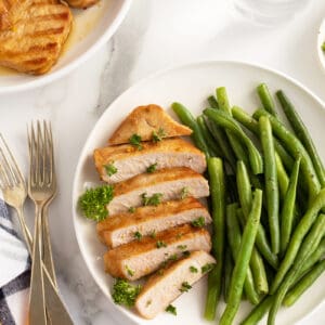 Kentucky bourbon grilled pork chops on a plate with green beans