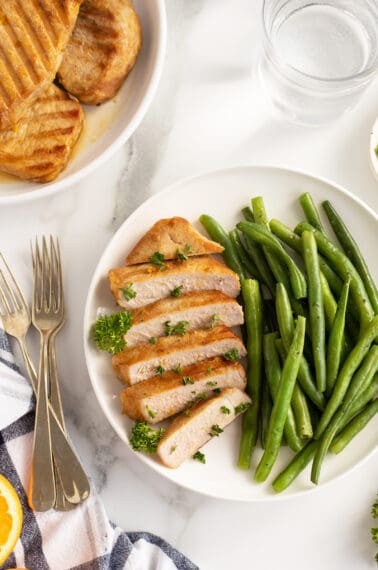Kentucky bourbon grilled pork chops on a plate with green beans