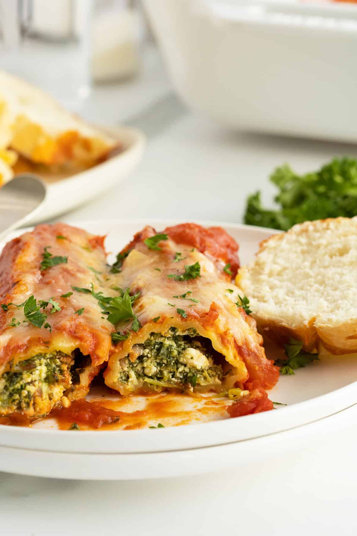 sausage stuffed manicotti on a white plate