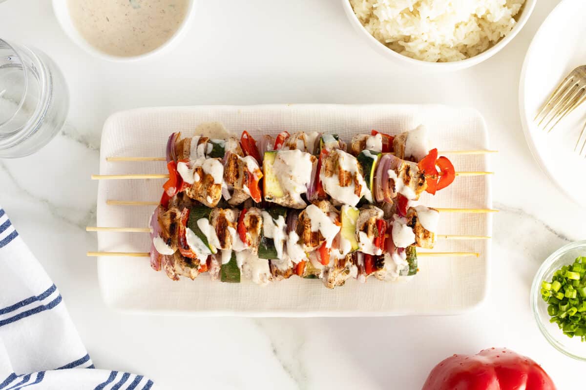 turkey kebabs on a white rectangular plate