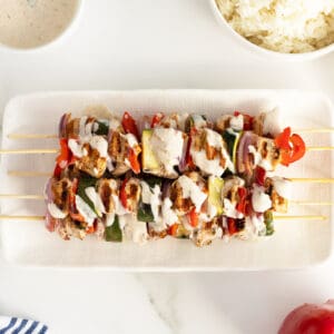 turkey kebabs on a white rectangular plate