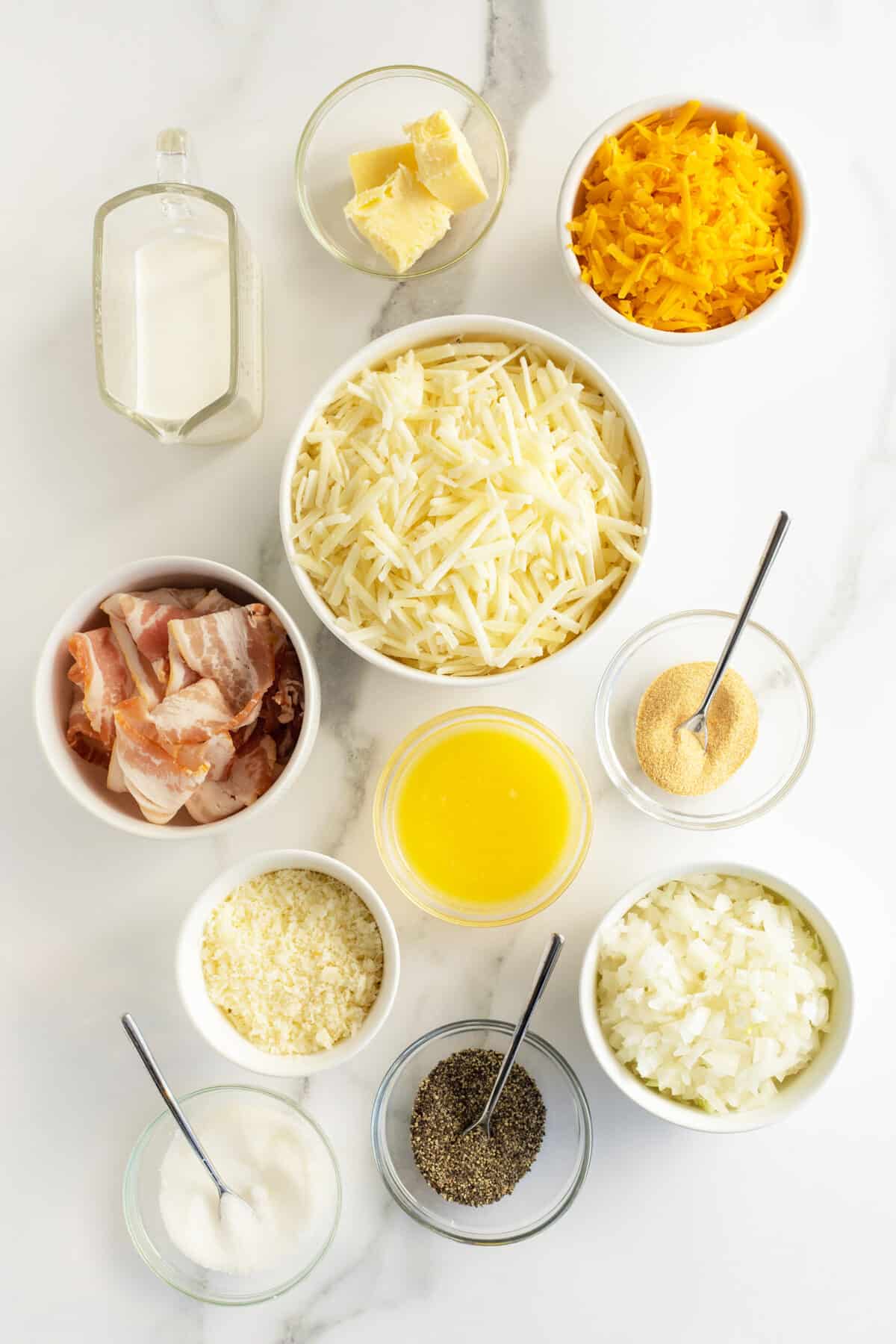cheesy hash brown casserole ingredients in small white bowls