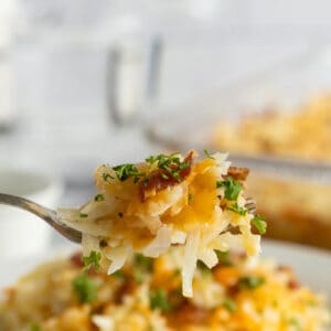 cheesy hash brown casserole lifted on a fork