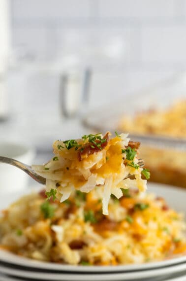 cheesy hash brown casserole lifted on a fork