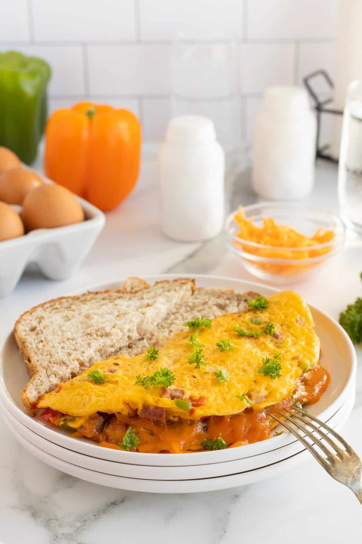 an omelet on a white plate with a slice of brown bread