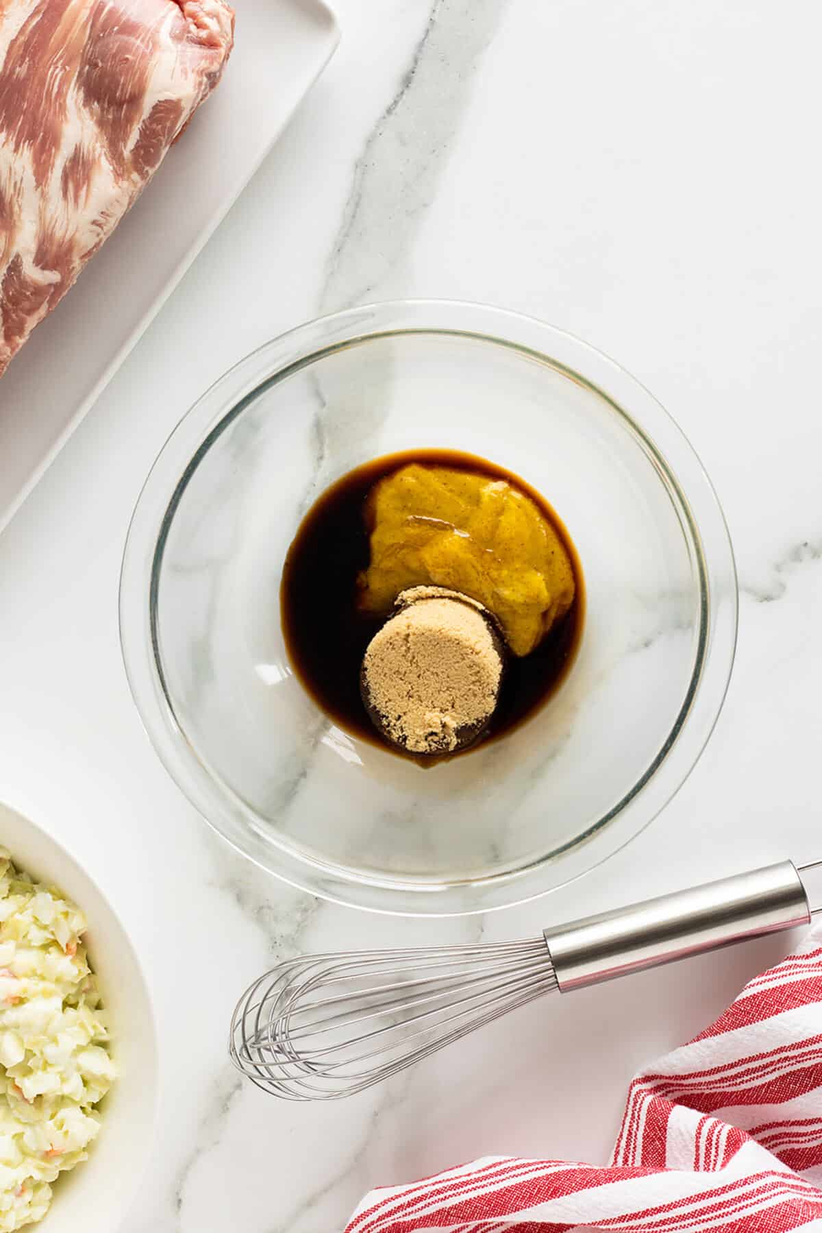 honey mustard glazed ribs sauce in a clear bowl unmixed