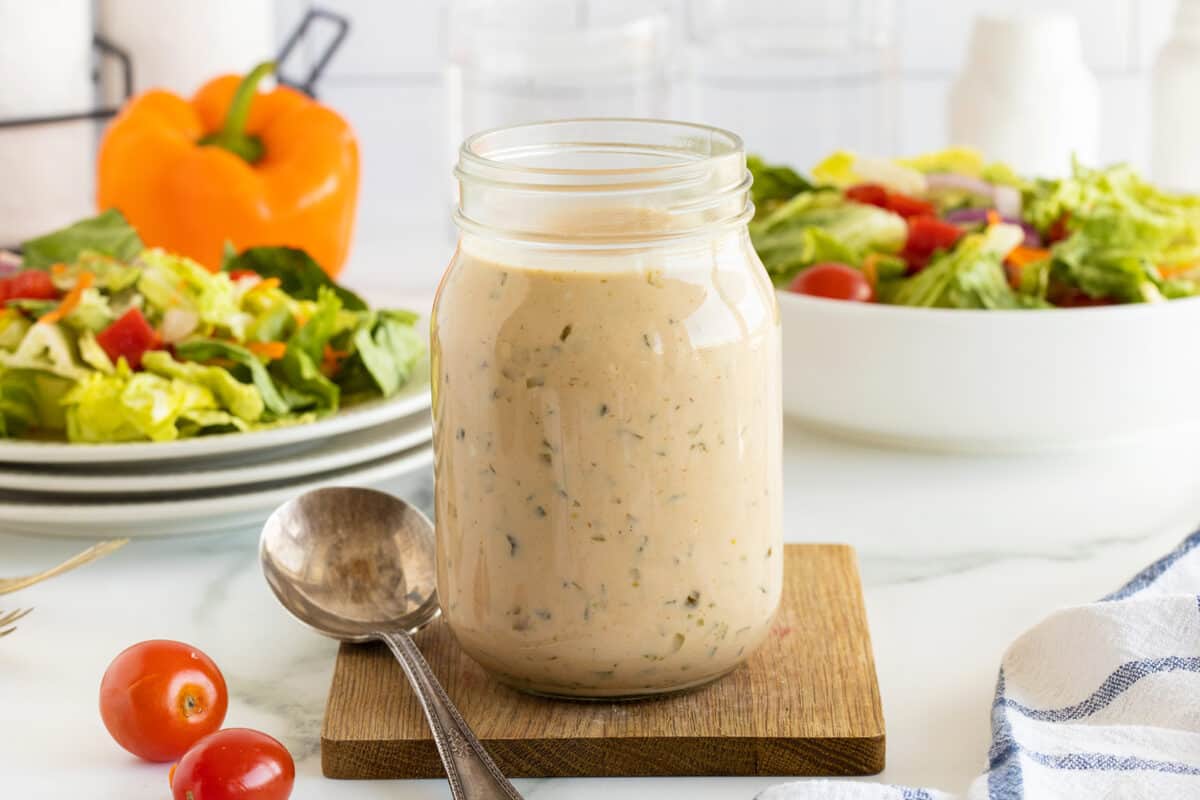 thousand island dressing IN A MASON JAR WITH CHERRY TOMATOES BESIDE IT