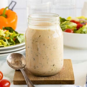thousand island dressing IN A MASON JAR WITH CHERRY TOMATOES BESIDE IT