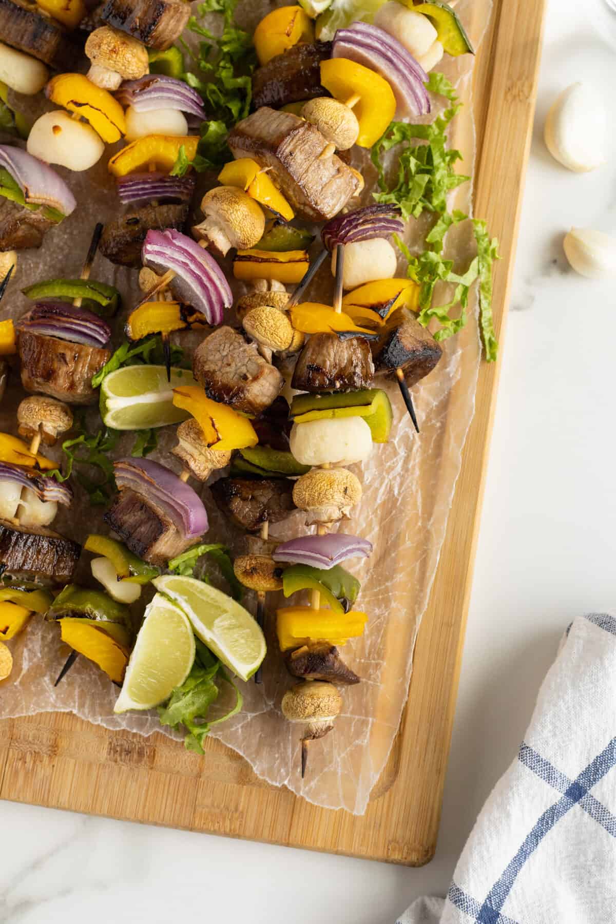 beef kabobs on skewers on a cutting board
