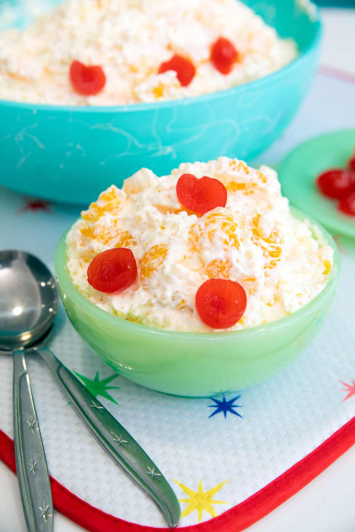 frog eye salad garnished with maraschino cherries