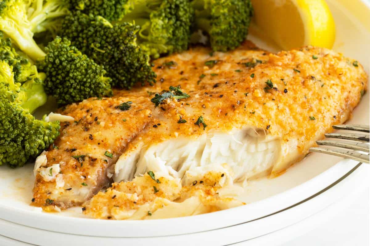 Parmesan crusted tilapia on a plate with broccoli