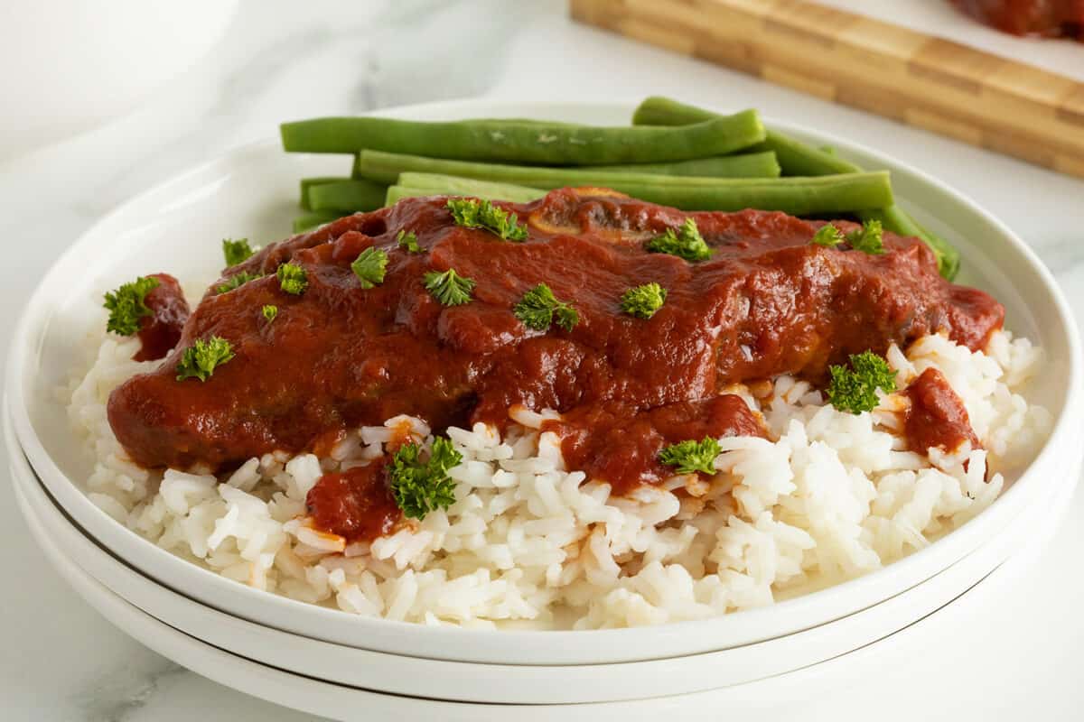 slow cooker short ribs on a plate with rice and green beans