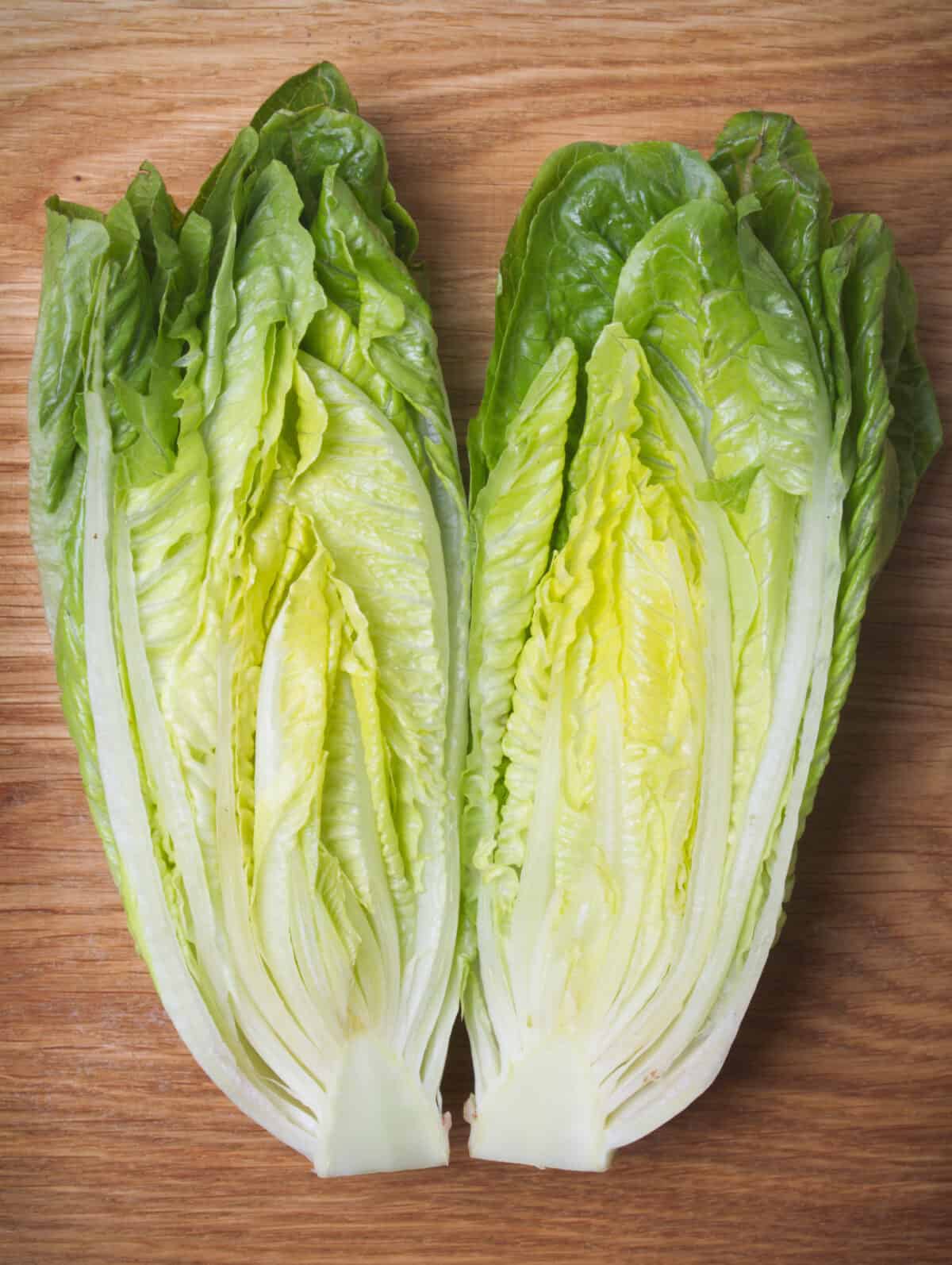 romaine lettuce sliced lengthwise on a cuttingboard