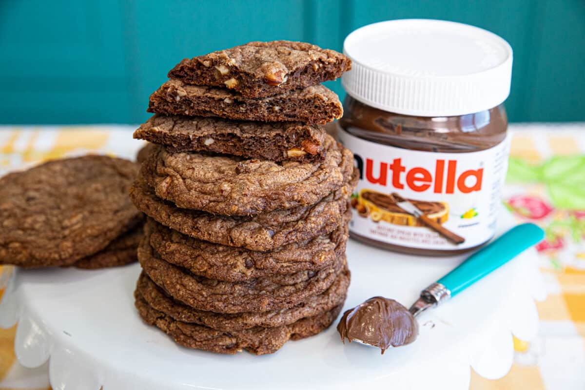 stack of Nutella cookies with a jar of Nutella