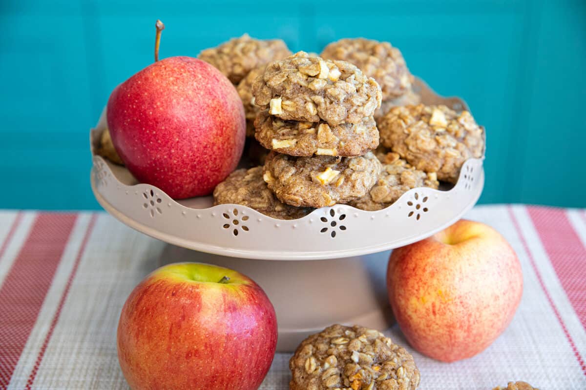 apple oatmeal cookies on a cake stand with apples 