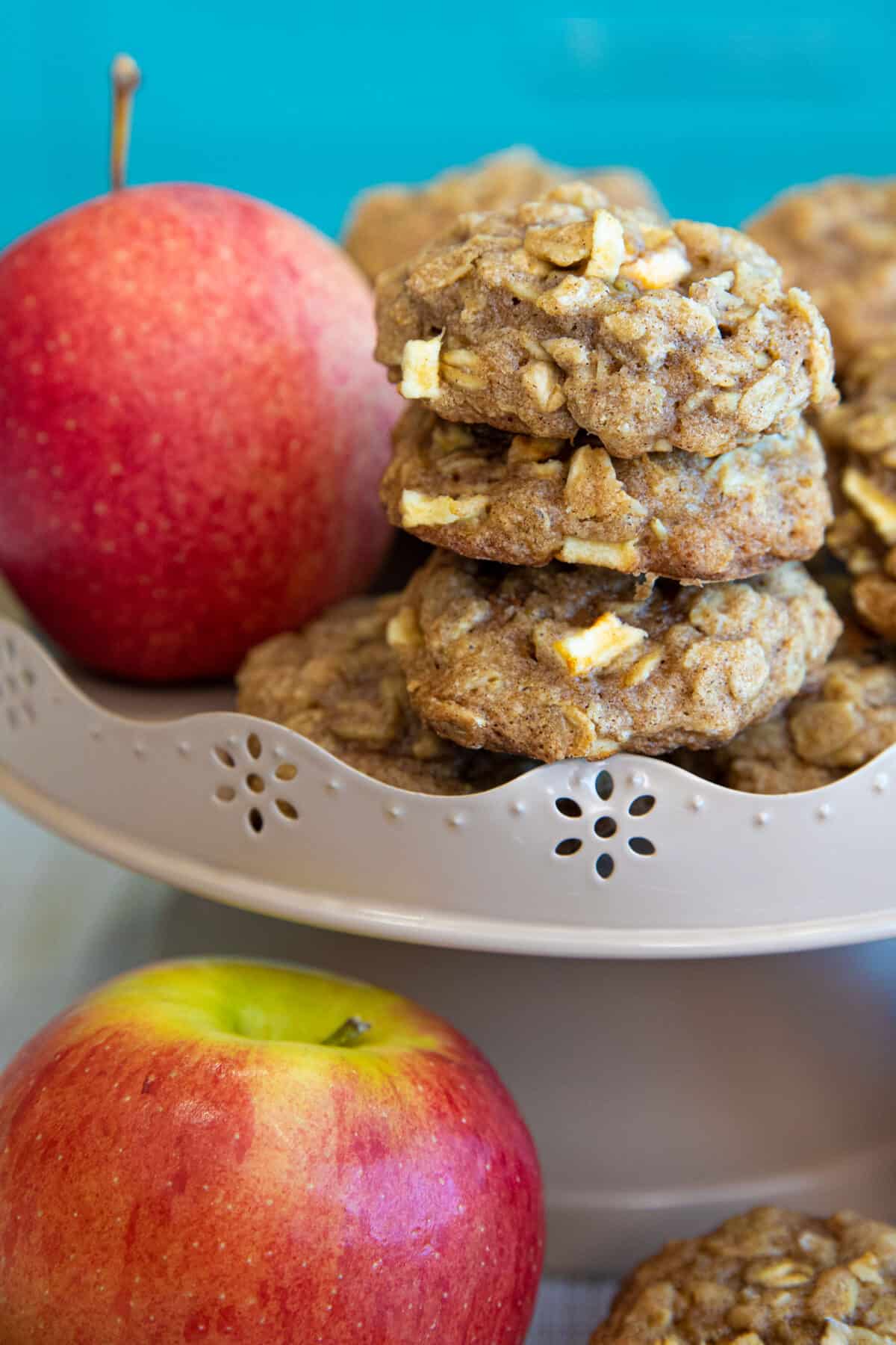 apple oatmeal cookies on a cake stand with apples 