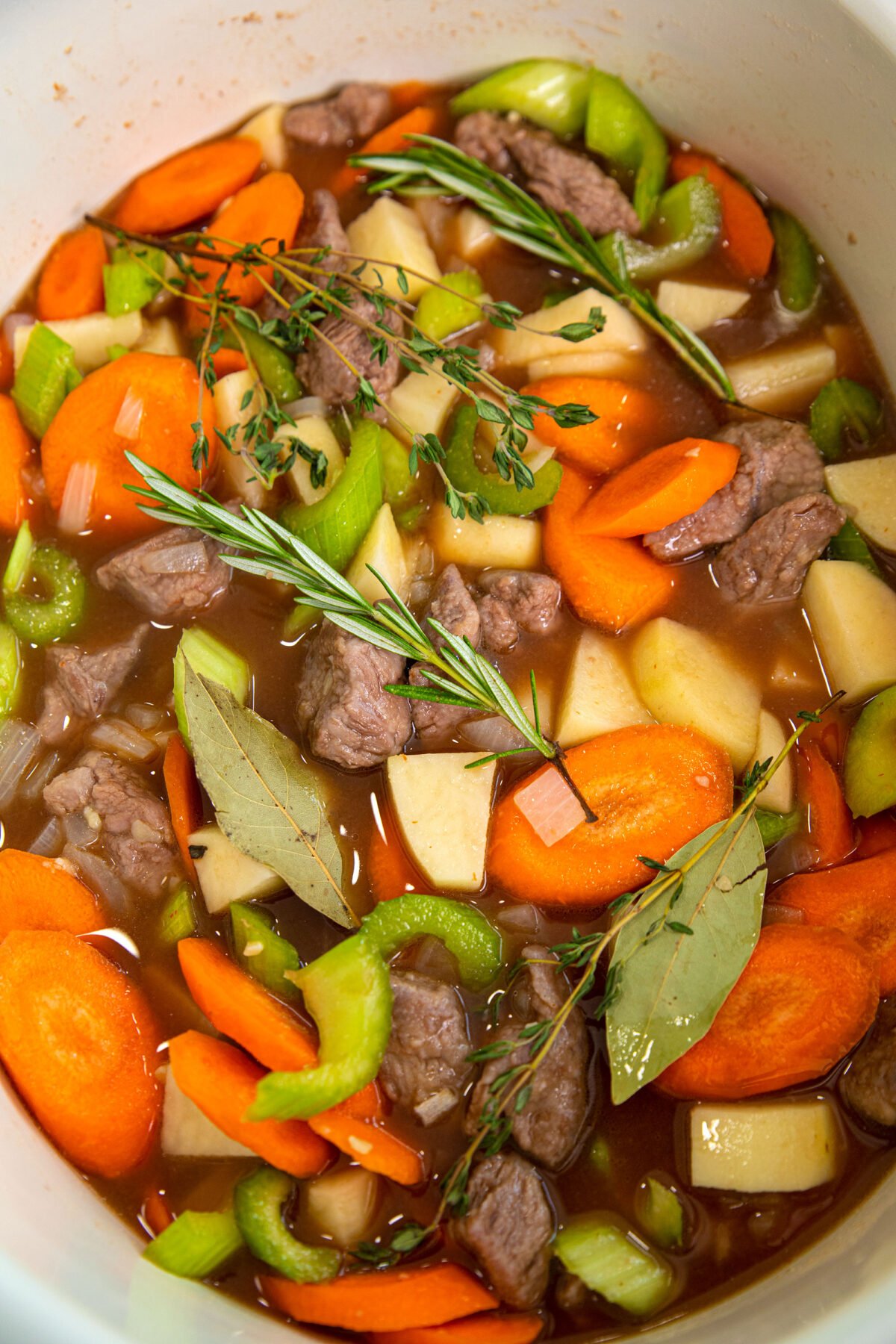 ingredients for lamb stew in a Dutch oven