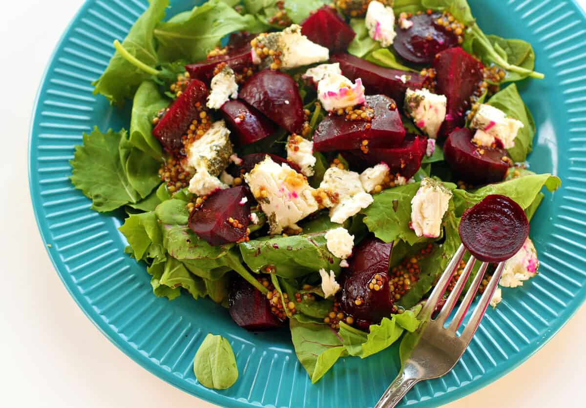 beets and goat cheese salad on a blue plate