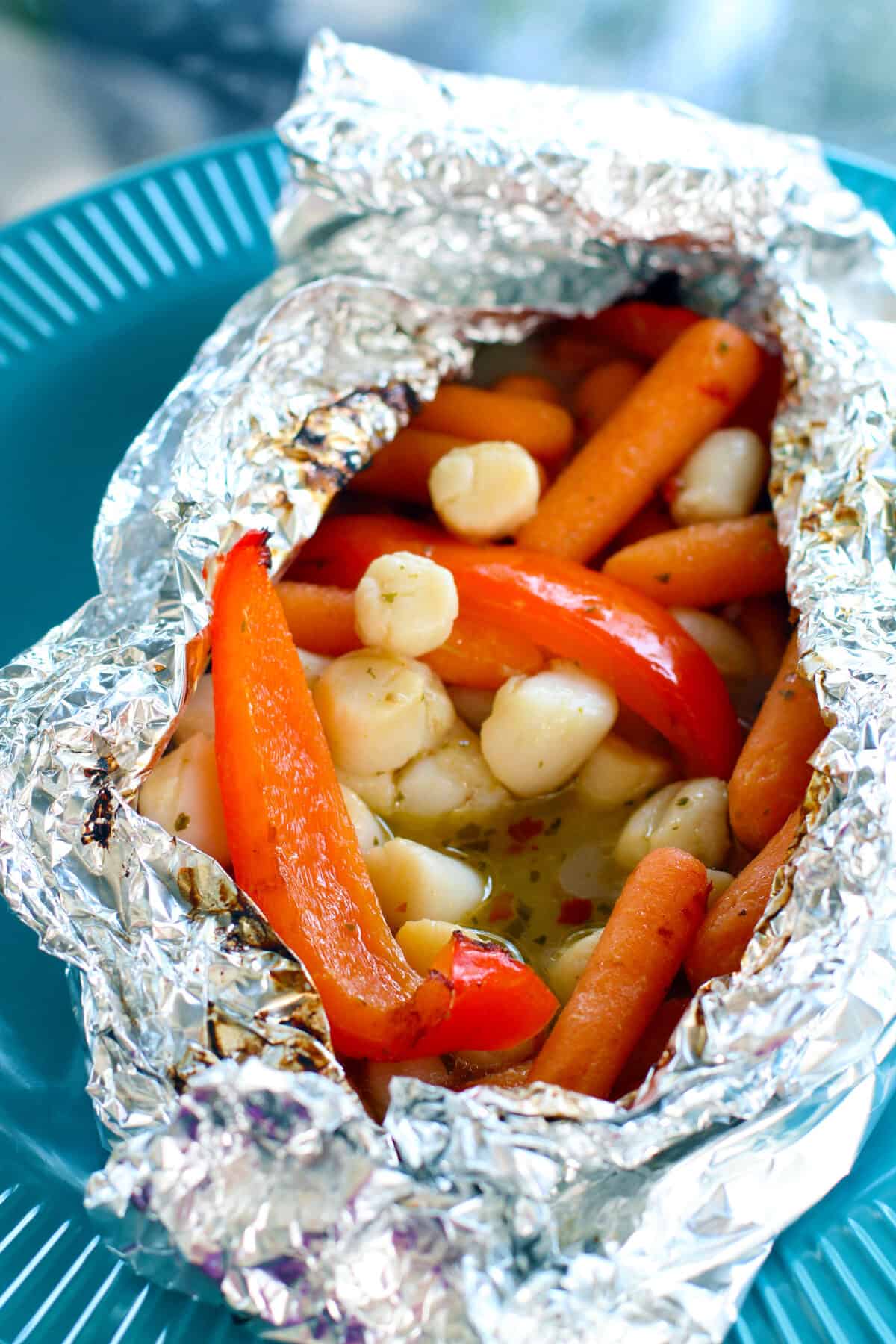 carrots, scallops and peppers in a campfire tinfoil packet
