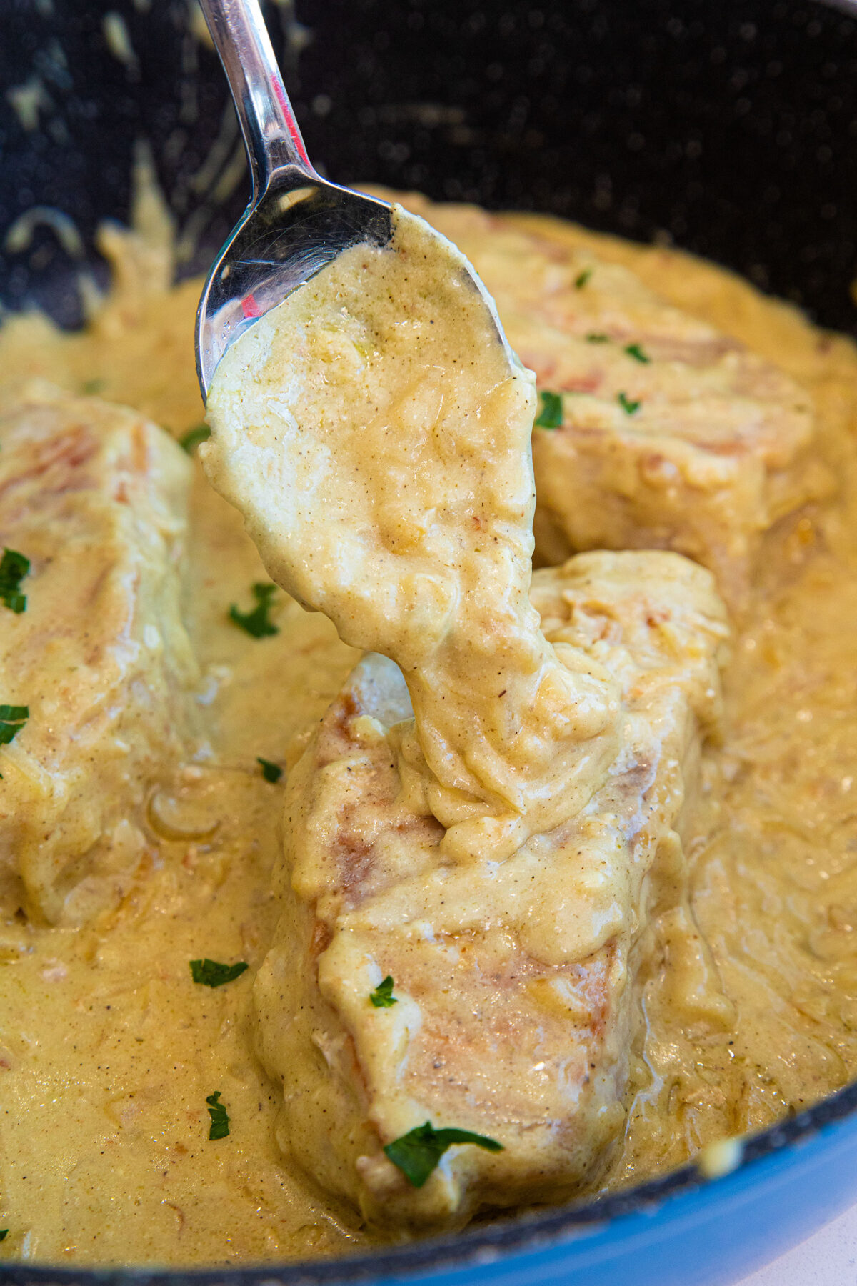 Classic smothered pork chops are a fantastic way to eat pork chops! Thick pork chops are cooked to crispy perfection and a rich sauce makes for the perfect family meal! #thekitchenmagpie #porkchopsrecipe #porkchops #easyrecipe