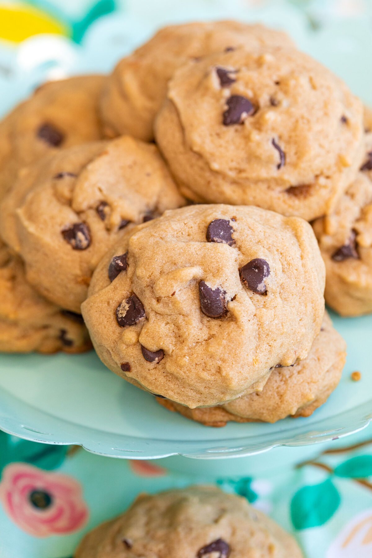 soft cakey chocolate chip cookies in a pile on a turquoise platter