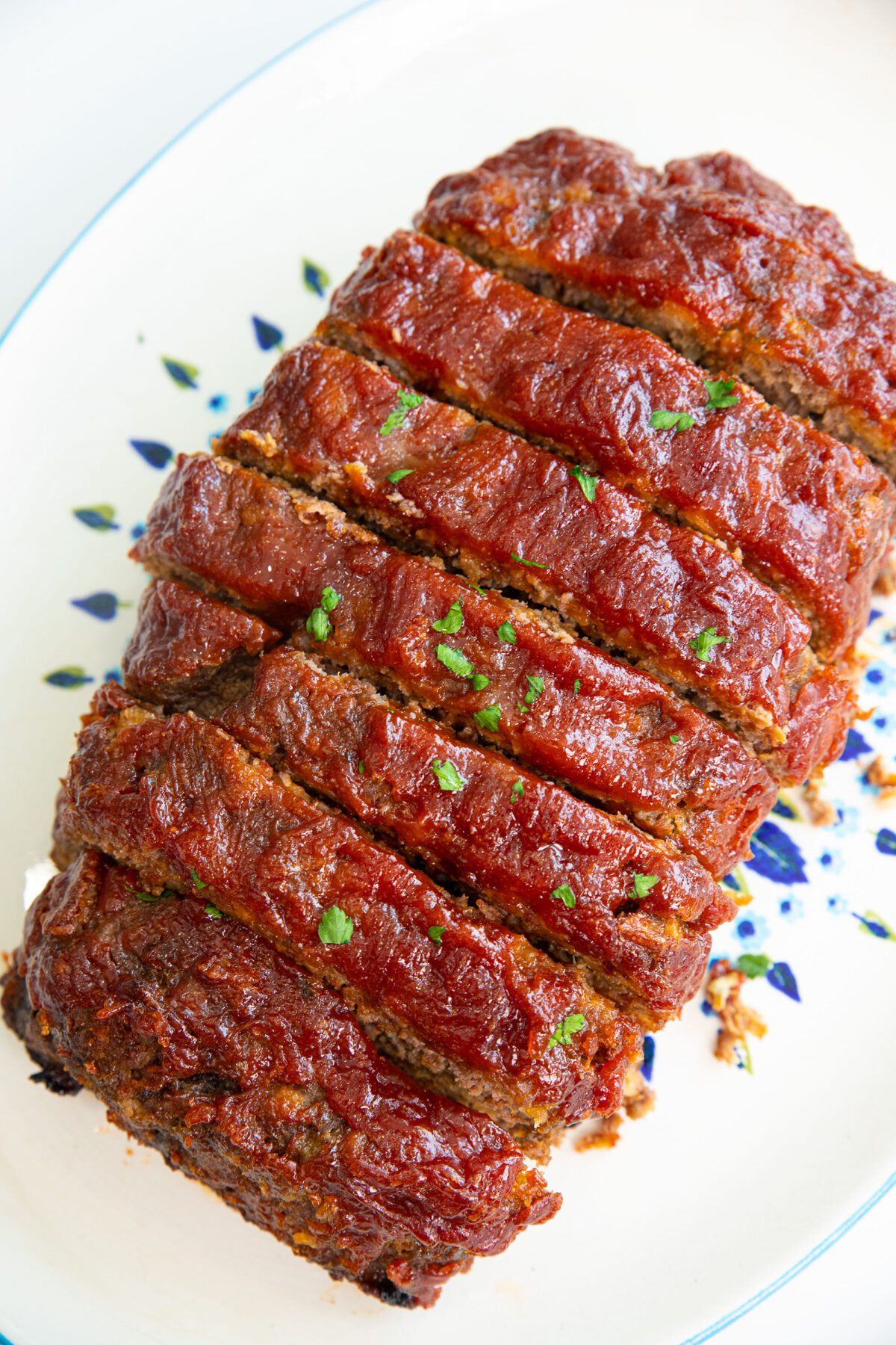 sliced homemade stove top stuffing meat loaf covered in my meat loaf sauce. 