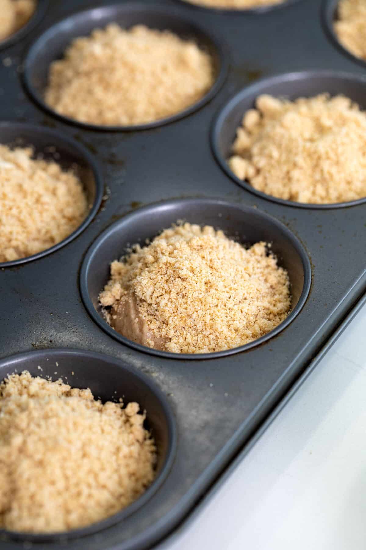 Cinnamon muffins with strusel on top unbaked