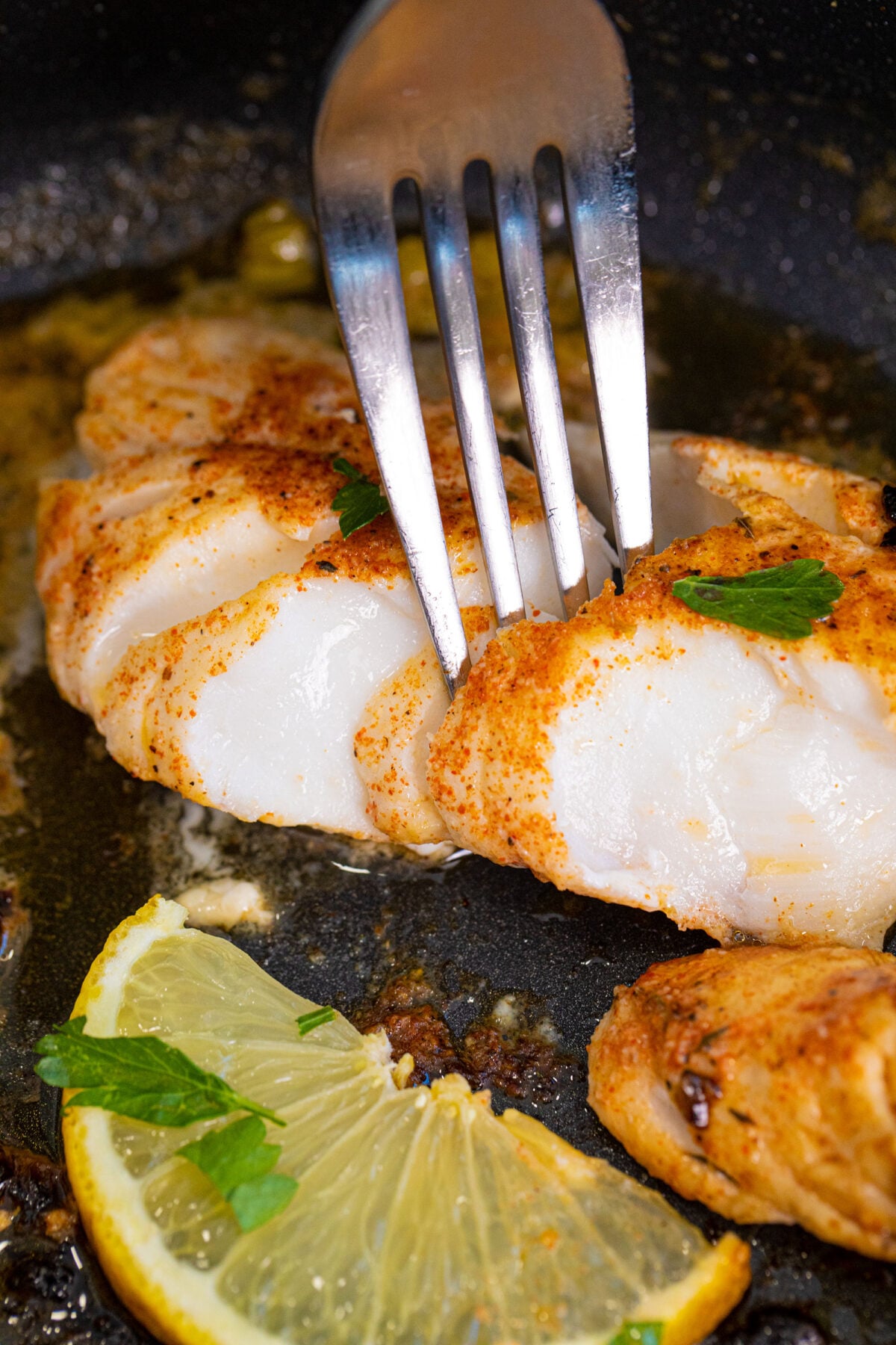 Affordable and healthy, cod is a mild-tasting white fish that is delicious when pan-fried in butter with Cajun seasonings and garnished with lemon juice. A fast meal that is perfect for any day of the week! #thekitchenmagpie #cod #bakedcod #familymeals
