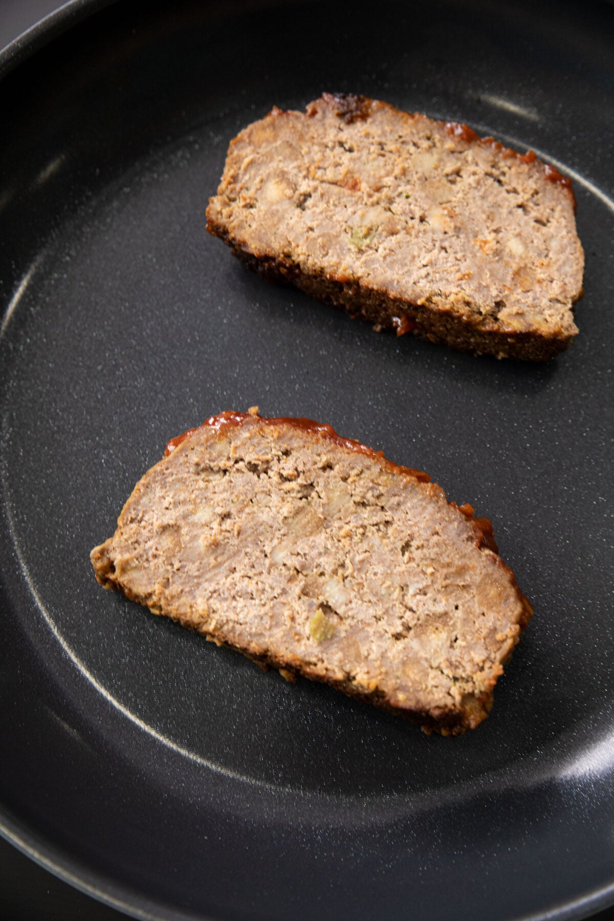 meatloaf being reheated in a pan