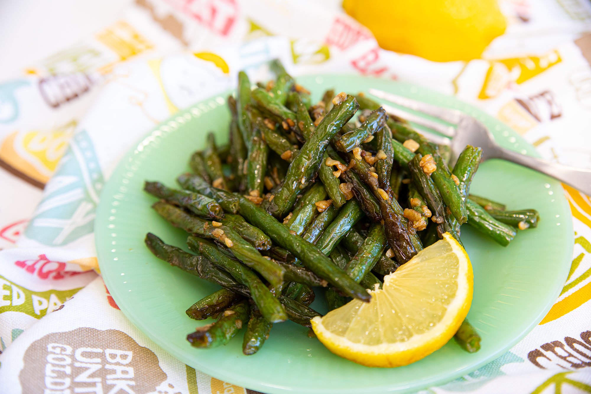 Simple sautéed green beans served on a plate.