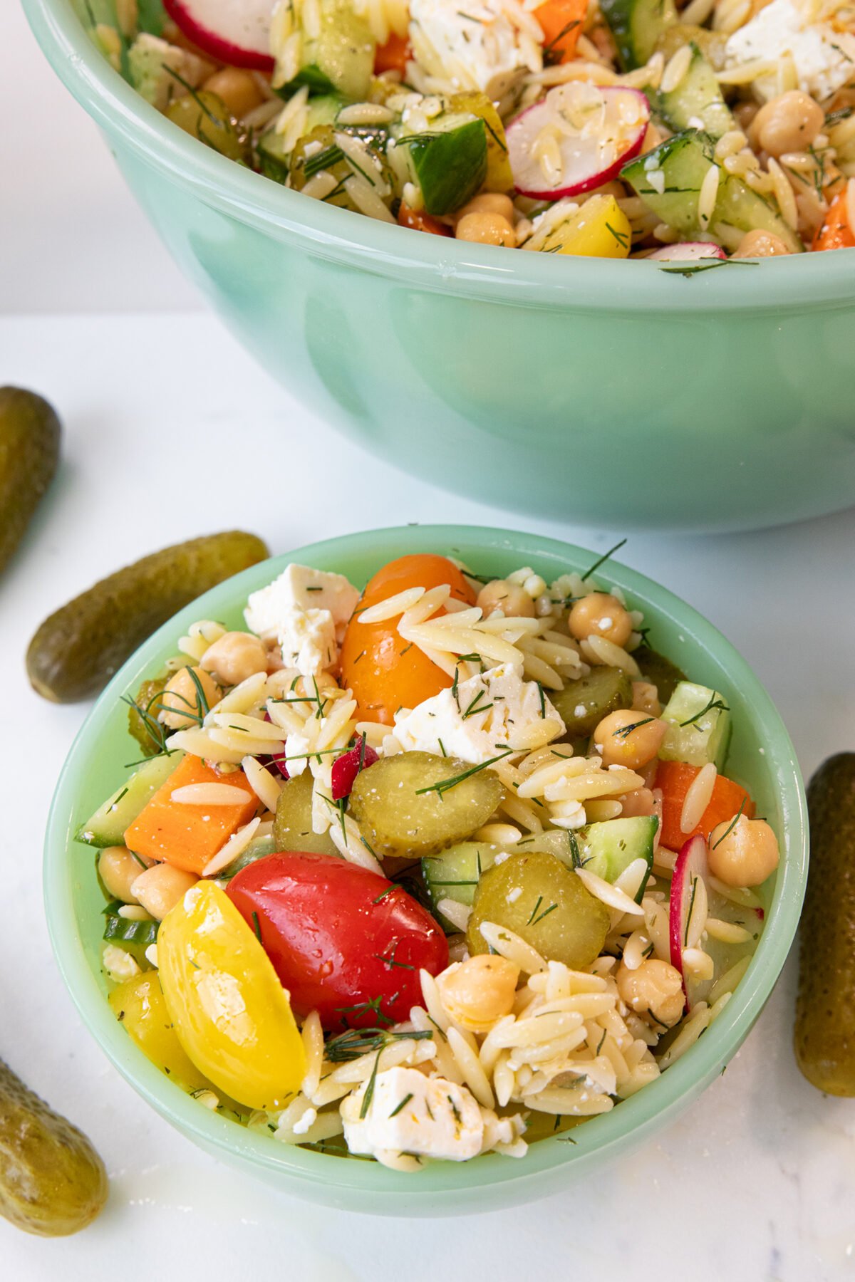 dill pickle chickpea orzo salad in a small Jadeite bowl