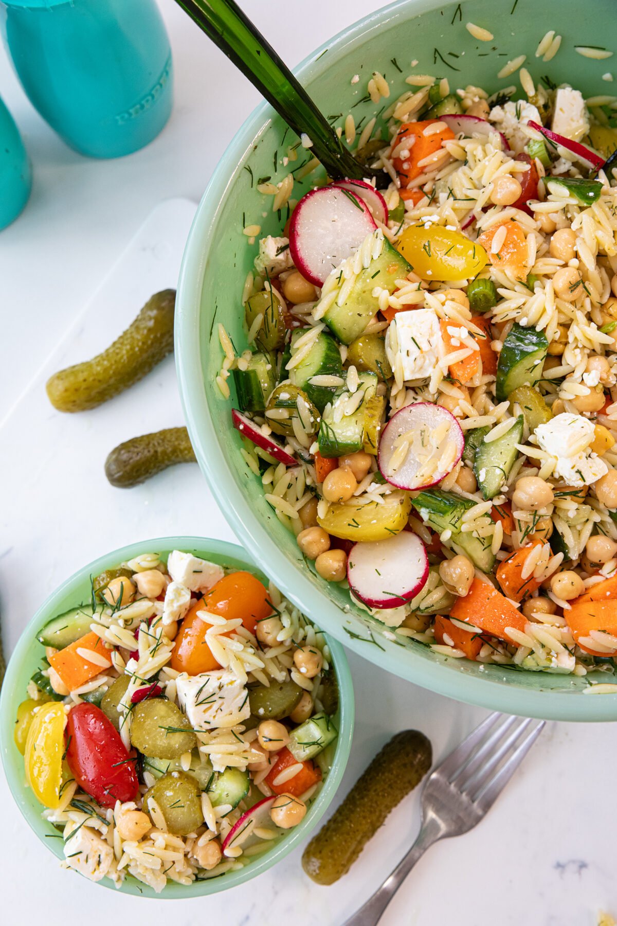 dill pickle chickpea orzo salad in green bowls